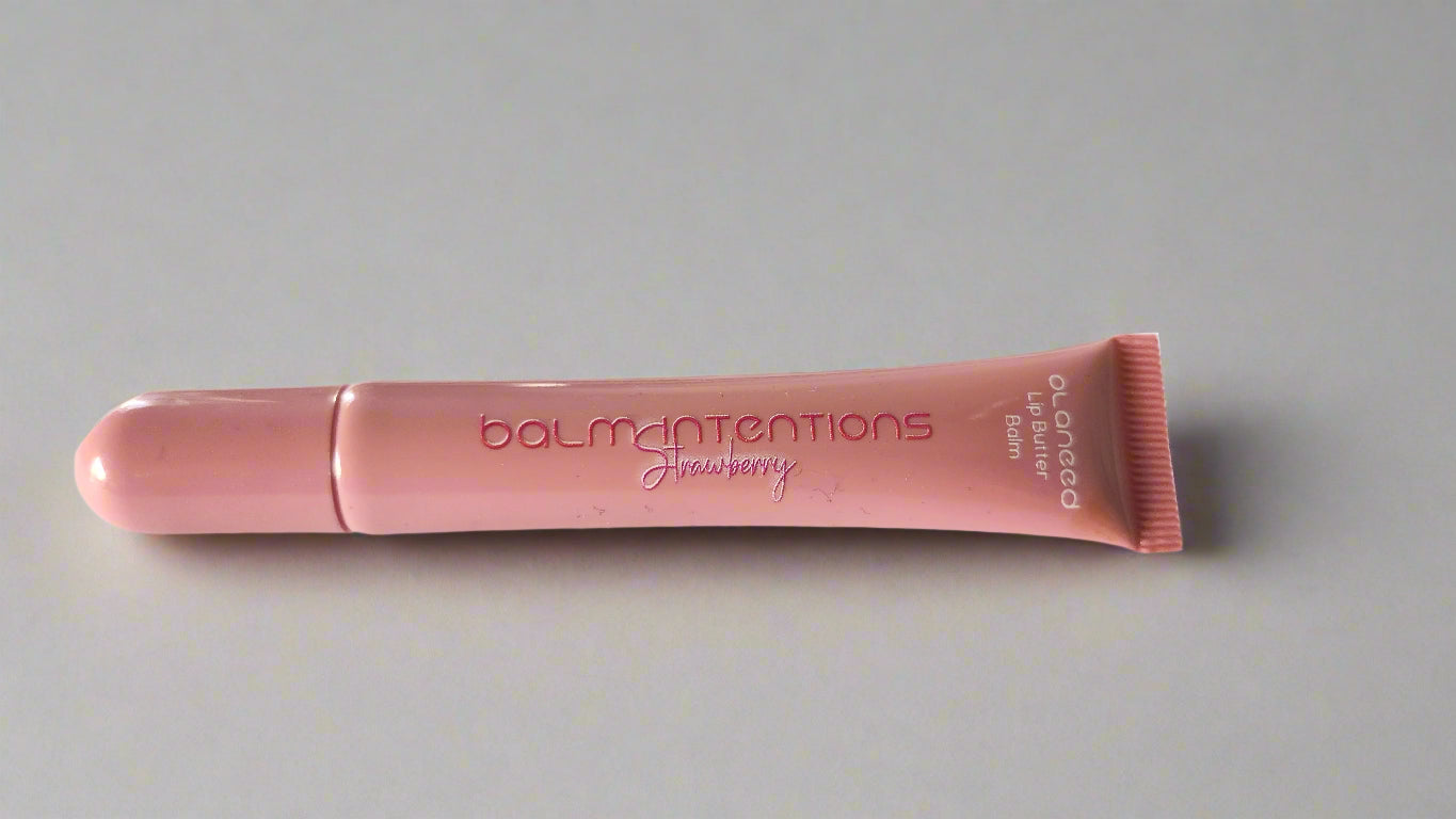 Pink lip balm with 'balm intentions' text on a white background
