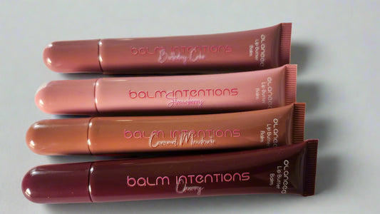 Four lip balm tubes from the brand 'balm intentions' on a white background