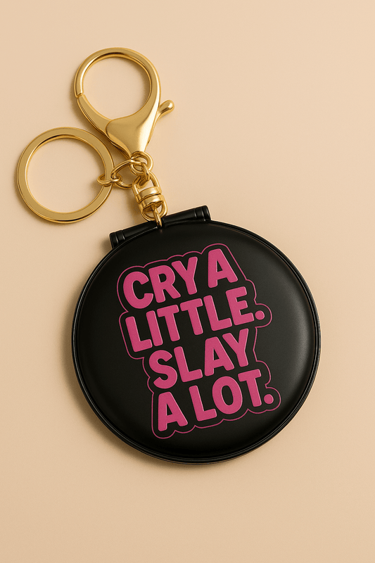 Keychain mirror with the phrase 'Cry a little. Slay a Lot.' for quick touch-ups and confidence.