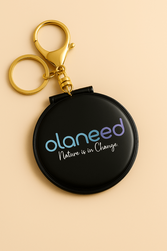 Olaneed keychain mirror showcasing the phrase 'Nature is in Change' on a sleek black design.